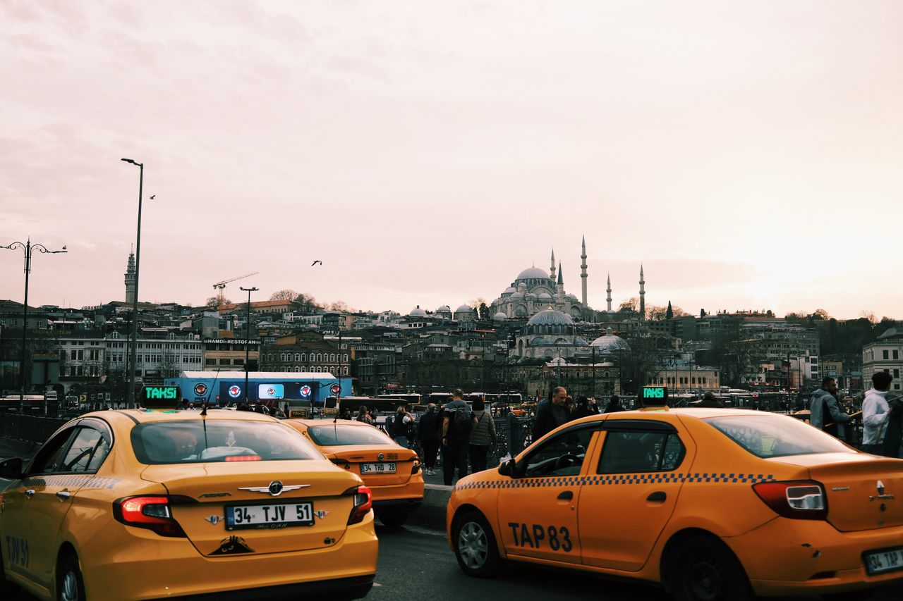 The Art of Drawing Readers In: Your attractive post title goes here Yellow taxis navigate busy Istanbul streets with iconic mosques in the background.