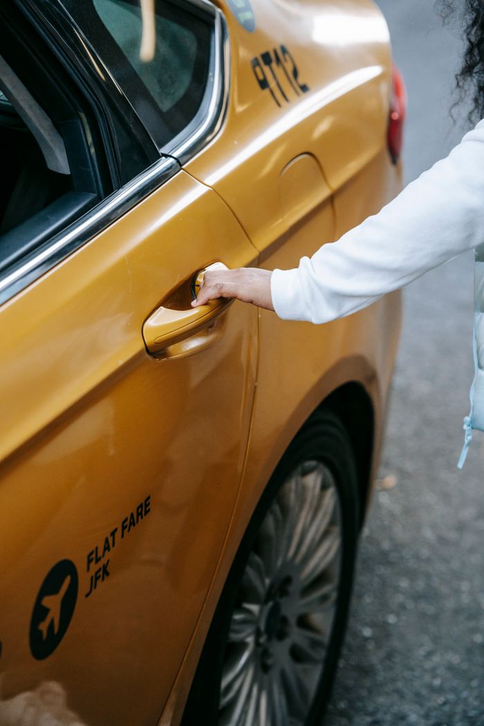 Mastering the First Impression: Your intriguing post title goes here Crop unrecognizable ethnic lady in casual outfit opening door of yellow taxi in city street in daylight
